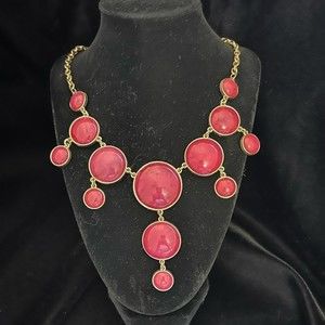 Pink bubble bib necklace on gold colored chain in Barbie pink